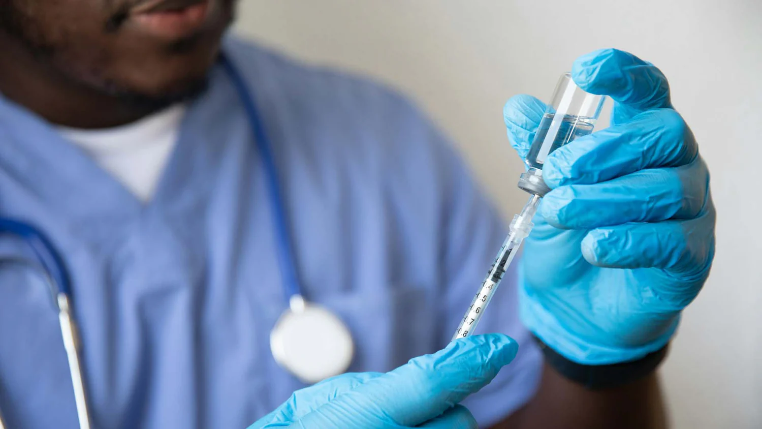 Doctor wearing blue nitrile gloves